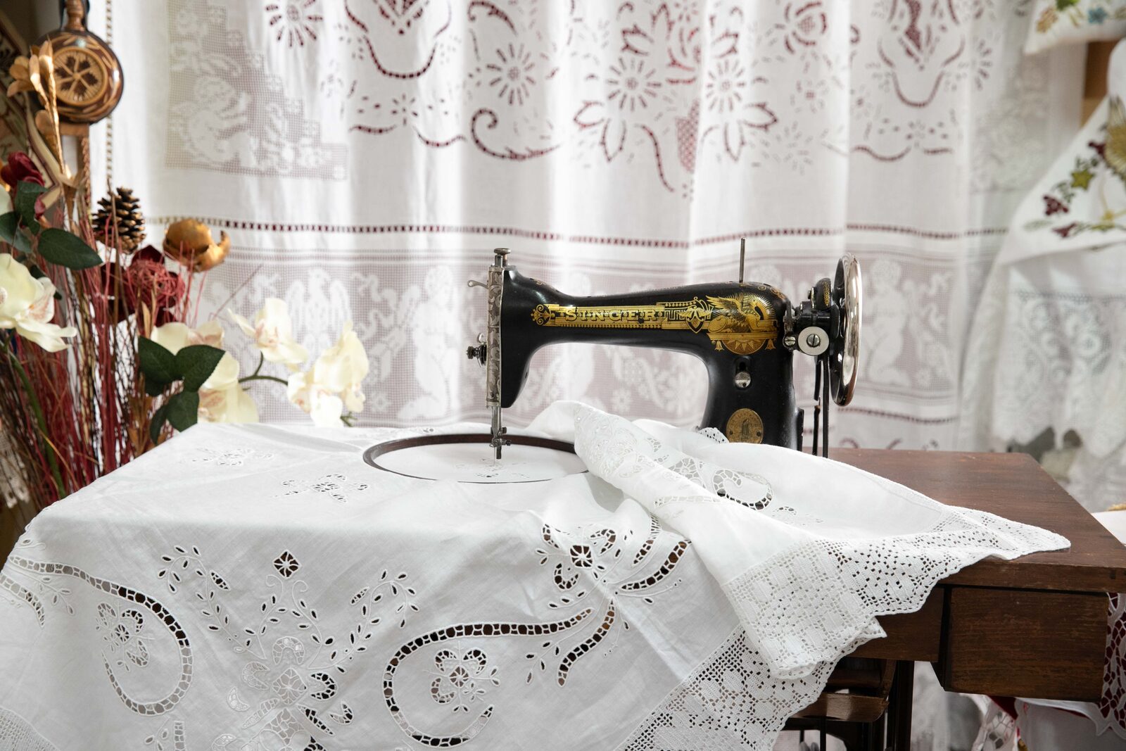 Vintage Singer sewing machine with handmade cutwork embroidery linen in the Embroider Riches Athens workshop