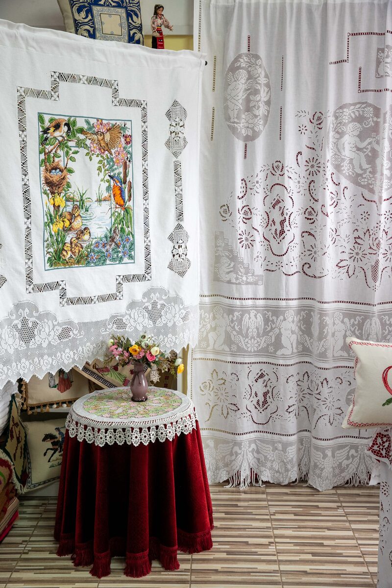 Embroider Riches storefront in Athens with embroidered textiles in the window display