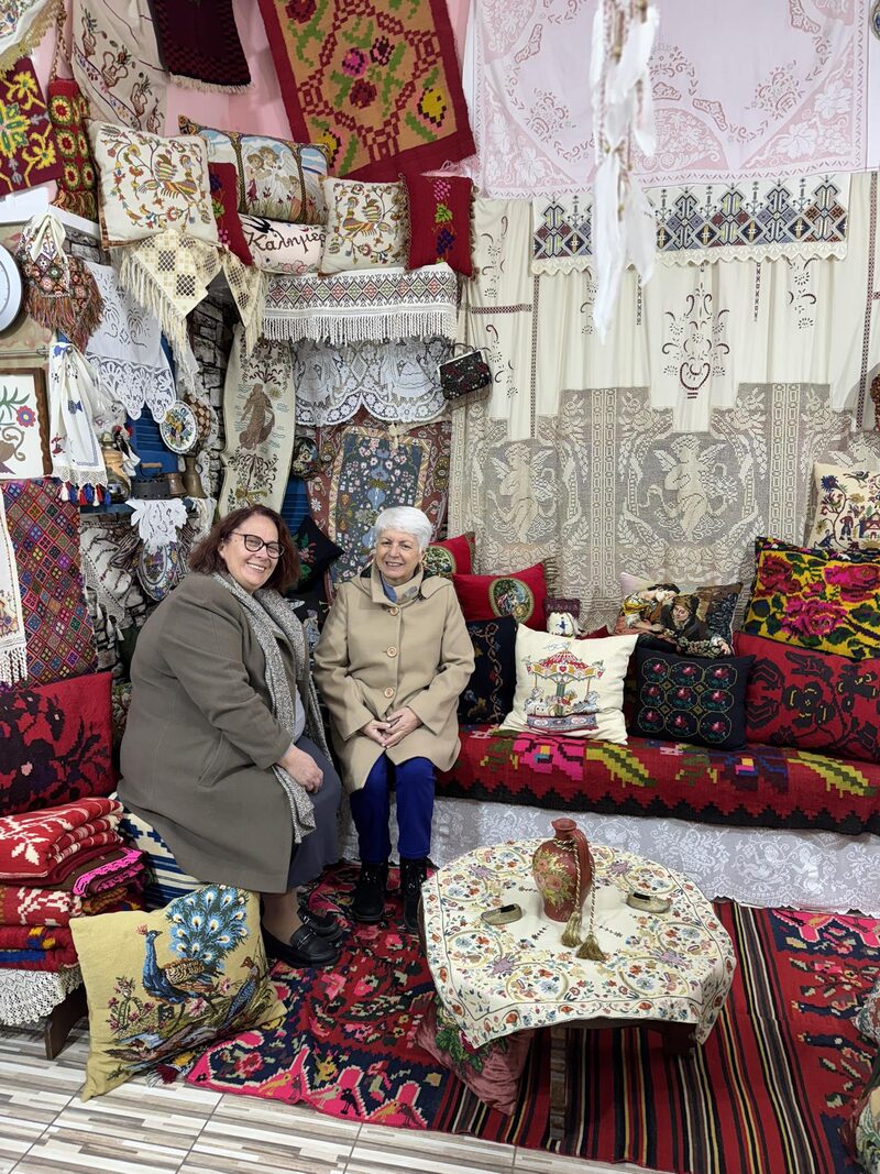 Visitors surrounded by handmade textiles and folk embroideries in the Embroider Riches Athens atelier